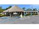 Beachside restaurant with a thatched roof hut and outdoor seating at 8625 Midnight Pass Rd # 505B, Sarasota, FL 34242