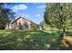 Spacious backyard with lush green grass and mature trees at 9443 Burnam Dr, Weeki Wachee, FL 34613