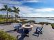 Relaxing fire pit area with lake views and palm trees at 969 Crosswind Ave, Sarasota, FL 34240