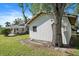 Detached garage with a single window and large oak tree at 1005 Hines Ave, Sarasota, FL 34237