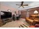 Bedroom featuring a TV, desk, ceiling fan, and a comfortable recliner sofa at 1121 Danny Dr, Sarasota, FL 34243