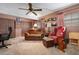 Den with brown leather furniture, ceiling fan, and golf decor at 1121 Danny Dr, Sarasota, FL 34243