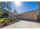 Front view of newly renovated home with garage and landscaping at 1155 Tahiti Pkwy, Sarasota, FL 34236