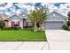 The home features a gray exterior, red shutters, and a well-manicured lawn at 11924 Persian Ter, Bradenton, FL 34212