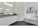 Bathroom with a soaking tub and double vanity at 13126 Indigo Way, Bradenton, FL 34211