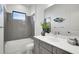 Bathroom with gray tile and modern vanity at 13126 Indigo Way, Bradenton, FL 34211