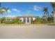Community clubhouse with a tiled roof and landscaping at 13126 Indigo Way, Bradenton, FL 34211
