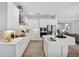 Modern kitchen with white cabinets, stainless steel appliances, and a large island at 13126 Indigo Way, Bradenton, FL 34211