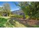 Landscaped backyard with lush greenery and mature trees at 13126 Indigo Way, Bradenton, FL 34211