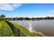 Expansive backyard view featuring a serene lake and meticulously maintained landscaping in a waterfront community at 13789 Old Creek Ct, Parrish, FL 34219