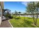 A screened lanai overlooks the spacious backyard, the beautiful lake, and tropical landscaping at 13789 Old Creek Ct, Parrish, FL 34219