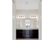 Bathroom features double vanity with granite countertop and decorative lighting at 13789 Old Creek Ct, Parrish, FL 34219