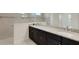 Bathroom with a double granite vanity, tiled walls and frameless glass shower at 13789 Old Creek Ct, Parrish, FL 34219
