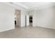 Open bedroom showcasing neutral tile flooring and clear sight lines to an en-suite bathroom and walk-in closet at 13789 Old Creek Ct, Parrish, FL 34219