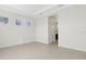 Bright bedroom features tile flooring, three windows, and access to the ensuite bathroom at 13789 Old Creek Ct, Parrish, FL 34219