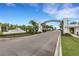 Grand entrance to Canoe Creek featuring an arched gateway and manicured landscaping in Parrish, FL at 13789 Old Creek Ct, Parrish, FL 34219