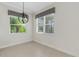 Bright dining area with tile floors, a window with blinds, and a modern light fixture, perfect for Gathering meals at 13789 Old Creek Ct, Parrish, FL 34219