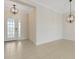 Bright entryway featuring neutral tile flooring, a decorative light fixture, and a white front door with sidelights at 13789 Old Creek Ct, Parrish, FL 34219