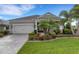 Charming single-story home featuring a two-car garage, landscaped yard, and a paver driveway at 13789 Old Creek Ct, Parrish, FL 34219