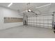 Well-lit garage featuring epoxy flooring, overhead storage, and wall-mounted organization system for optimal space utilization at 13789 Old Creek Ct, Parrish, FL 34219