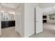 Hallway view showing a spacious bathroom and kitchen, with ample natural light at 13789 Old Creek Ct, Parrish, FL 34219