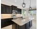 Modern kitchen with stainless steel appliances, granite countertops and stylish lighting fixtures at 13789 Old Creek Ct, Parrish, FL 34219