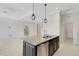 Kitchen island featuring granite countertop, stainless steel dishwasher, and dark wood cabinets in an open-concept area at 13789 Old Creek Ct, Parrish, FL 34219