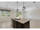 Island with granite countertop, stainless steel dishwasher, and dark wood cabinets in a bright, open area at 13789 Old Creek Ct, Parrish, FL 34219