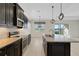 Kitchen with stainless steel appliances, granite countertops, tile backsplash, and an island with a sink at 13789 Old Creek Ct, Parrish, FL 34219