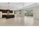 Open kitchen and living area with a kitchen island, stainless appliances, and tile flooring at 13789 Old Creek Ct, Parrish, FL 34219