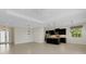 Open-concept living room showcasing the kitchen with island, tile flooring, recessed lighting, and an airy design at 13789 Old Creek Ct, Parrish, FL 34219