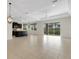 A spacious living area with tile flooring, kitchen view, and a sliding glass door that allows for natural light at 13789 Old Creek Ct, Parrish, FL 34219