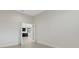 Open living room area with neutral tile flooring, bright white walls, and clear sight lines to other rooms at 13789 Old Creek Ct, Parrish, FL 34219