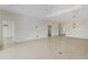 Spacious living room featuring neutral tile flooring, recessed lighting, and open access to other rooms in the house at 13789 Old Creek Ct, Parrish, FL 34219