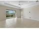 Bright living room with tile floors, sliding glass doors to the patio, and recessed lighting in the tray ceiling at 13789 Old Creek Ct, Parrish, FL 34219