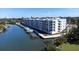 Aerial view of modern waterfront condo building with boat slips at 1709 N Tamiami Trl # 212, Sarasota, FL 34234