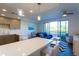 Modern kitchen with breakfast bar, white counters, and gray cabinets at 1709 N Tamiami Trl # 212, Sarasota, FL 34234
