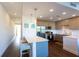 Modern kitchen features a breakfast bar and stainless steel appliances at 1709 N Tamiami Trl # 212, Sarasota, FL 34234