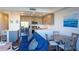 Open concept living room, kitchen, and dining area in condo at 1709 N Tamiami Trl # 212, Sarasota, FL 34234