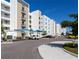 Condo building with parking lot and covered parking spaces at 1709 N Tamiami Trl # 212, Sarasota, FL 34234