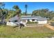 Elevated view of a single-story home with a gray roof, yellow door, and well-maintained lawn at 1725 Pocatello St, Sarasota, FL 34231