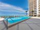 Resort-style pool with ocean views and ample lounge chairs at 2301 Gulf Of Mexico Dr # 85N, Longboat Key, FL 34228