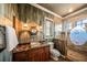 Nautical-themed bathroom with a walk-in shower and a unique sink at 275 Lookout Point Dr, Osprey, FL 34229