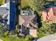 Aerial view of a home featuring a private pool, well-manicured lawn, and mature landscaping at 3113 Lakeside Cir, Parrish, FL 34219
