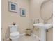 Powder room with pedestal sink, decorative accents, and neutral tones at 3113 Lakeside Cir, Parrish, FL 34219