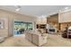 Bright living room features neutral tones, fireplace, and sliding doors to the lanai at 3113 Lakeside Cir, Parrish, FL 34219