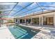 Inviting pool area with covered patio and lounge chairs at 3113 Lakeside Cir, Parrish, FL 34219