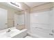 Simple bathroom with white fixtures, shower/tub combo, and a large mirror at 3255 Beneva Rd # 103, Sarasota, FL 34232