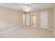 This bedroom features neutral walls, light-colored floors, and a ceiling fan at 3255 Beneva Rd # 103, Sarasota, FL 34232