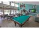 Community clubhouse with a billiard table, tables and chairs, and a TV at 3255 Beneva Rd # 103, Sarasota, FL 34232